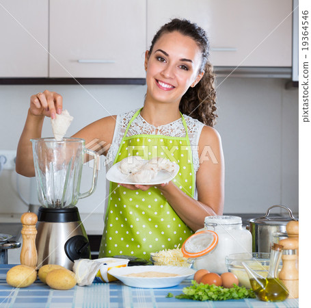 Woman with blender at kitchen. 19364546
