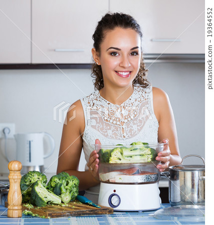 Girl preparing fish and veggies 19364552