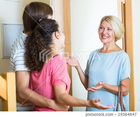 Mature woman visiting adult kids at their place 19364647