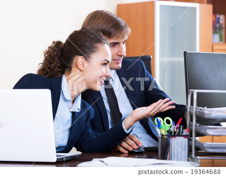 two happy employees in office 19364688