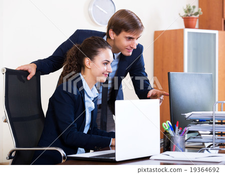 two happy employees in office 19364692