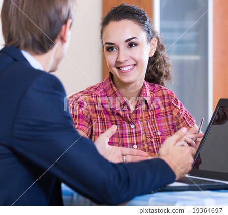 Insurance agent and customer discussing agreement terms Insurance agent and customer discussing agreement terms 19364697