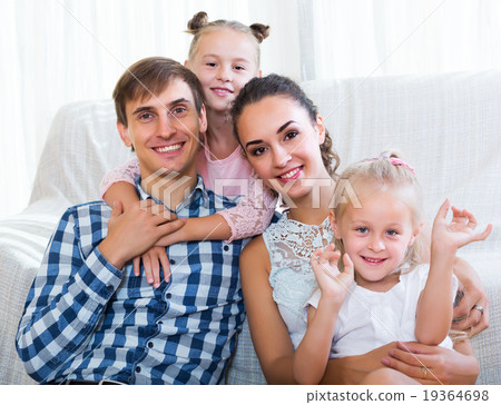 Relaxed family of four posing 19364698