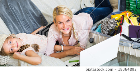 Family of two buying tickets online. Family of two buying tickets online. 19364892