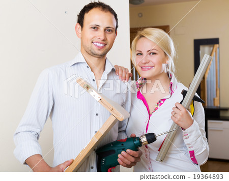 Couple choosing place for shelf 19364893