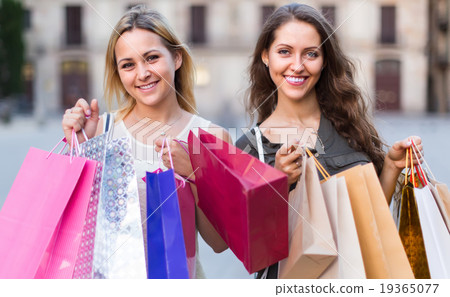 Girls with shopping bags at street. Girls with shopping bags at street. 19365077
