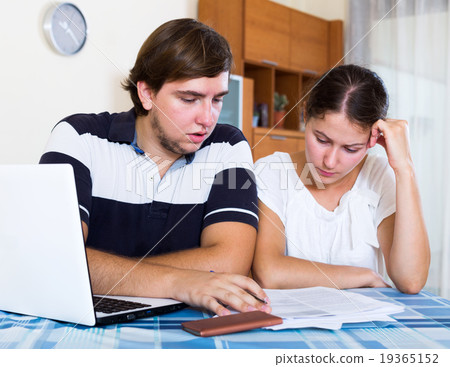 Couple sitting at desk Couple sitting at desk 19365152