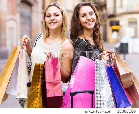 girls carrying bags with purchases girls carrying bags with purchases 19365190