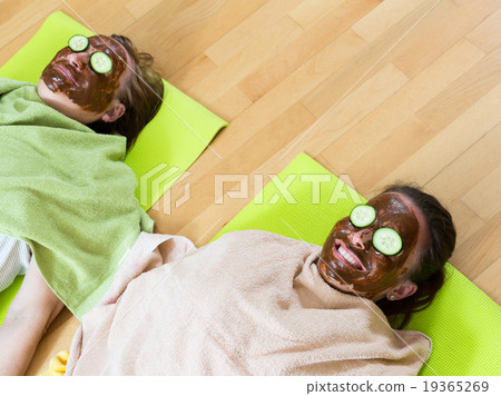 Women with a mask for face skin . Women with a mask for face skin . 19365269