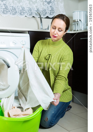 Sad woman near washing machine Sad woman near washing machine 19365663