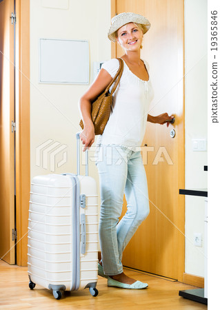 Girl standing with luggage 19365846