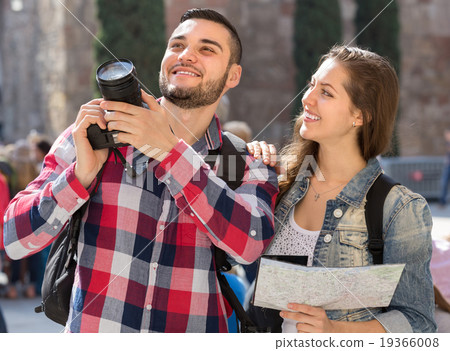 Tourist couple with camera in the city Tourist couple with camera in the city 19366008