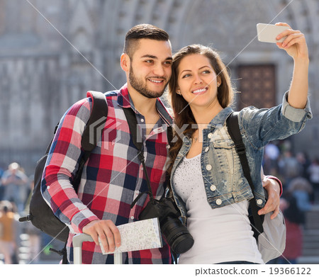 Couple with luggage doing selfie 19366122