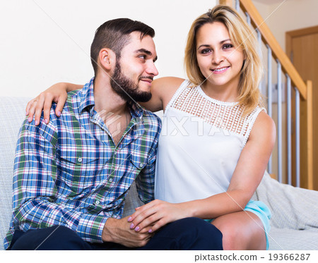 guy and cheerful pretty girl smiling indoors guy and cheerful pretty girl smiling indoors 19366287