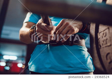 Athletes preparing for barbell exercises Athletes preparing for barbell exercises 19368524