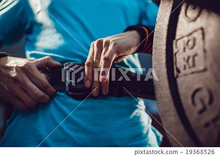 Athletes preparing for barbell exercises Athletes preparing for barbell exercises 19368526