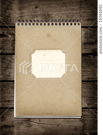 Closed spiral Note book on a dark wood table 19368992