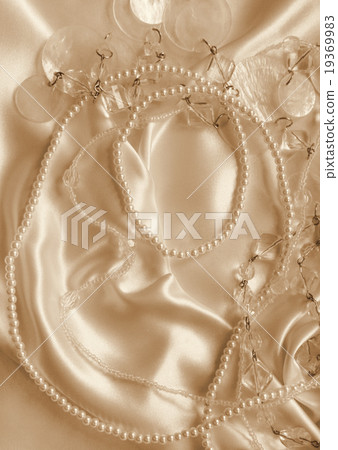 Pearls and nacreous beeds on silk as background Pearls and nacreous beeds on silk as background 19369983