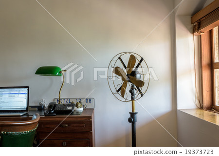 Office room with computer and fan 19373723