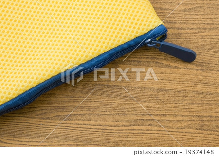 Yellow Bag with Blue Zipper on Wooden Board Yellow Bag with Blue Zipper on Wooden Board 19374148