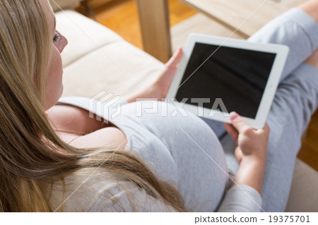 pregnant woman spends time with the tablet pregnant woman spends time with the tablet 19375701