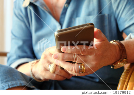 older woman using smart phone 19379912