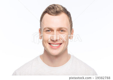 Handsome man is smiling broadly.  19382788