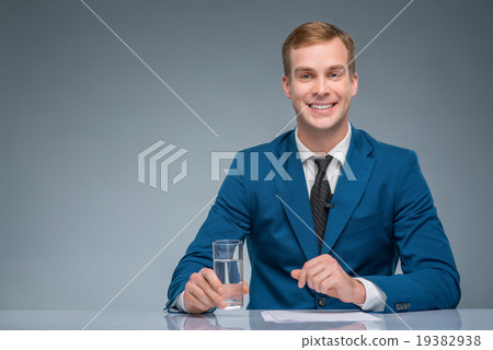 Smiling newscaster during broadcasting.  19382938