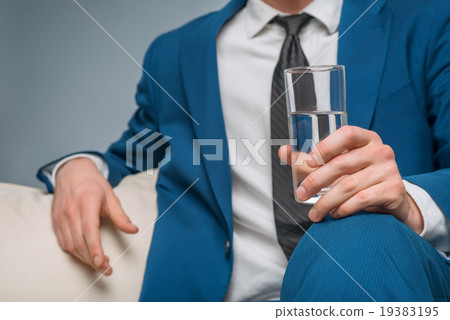 Handsome man holding a glass of water. Handsome man holding a glass of water. 19383195