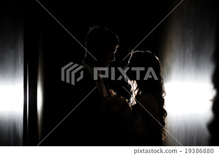 silhouette of the bride and groom at a wedding 19386880