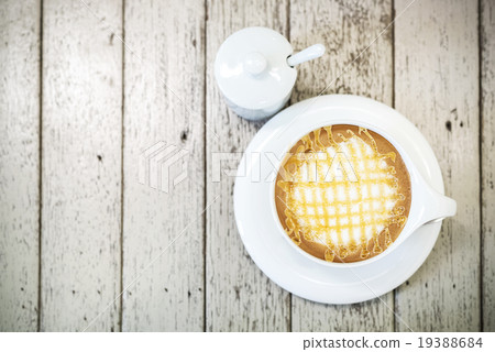 Cappuccino coffee in white cup on wood background. Cappuccino coffee in white cup on wood background. 19388684