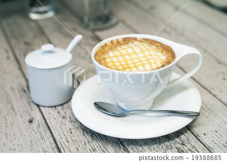 Cappuccino coffee in white cup on wood background. 19388685