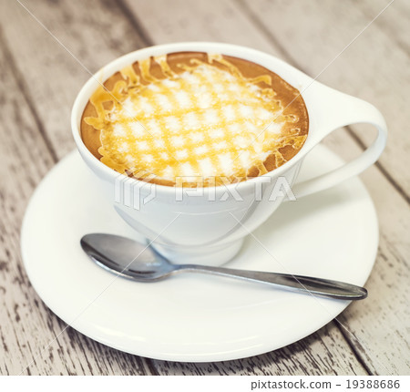 Cappuccino coffee in white cup on wood background. 19388686
