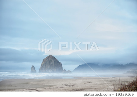Gorgeous hill in see surrounded by fog Gorgeous hill in see surrounded by fog 19389169