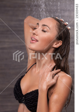 Cheerful young woman is washing in bathroom Cheerful young woman is washing in bathroom 19389483
