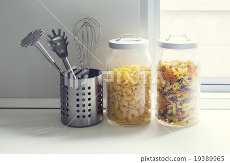 glass jars on natural stone countertop 19389965