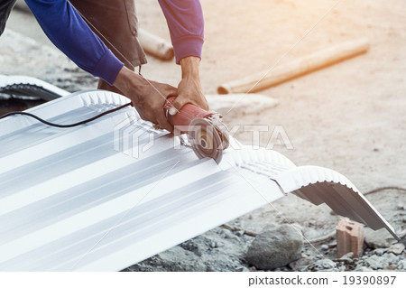 construction worker cutting roof for building 19390897