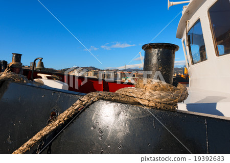 Ship Moored With Old Rope in a Harbor 19392683