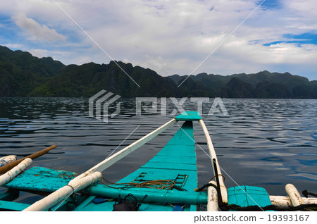 Tip of a Boat Facing ocean water and Mountain Tip of a Boat Facing ocean water and Mountain 19393167