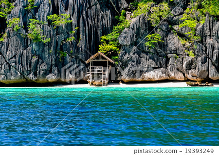 Lonely wooden bamboo house on stilts at a small Lonely wooden bamboo house on stilts at a small 19393249