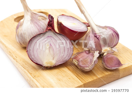 Garlic and onion on a wooden plate Garlic and onion on a wooden plate 19397770