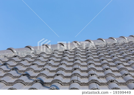 black roof tiles on house with blue sky 19399449