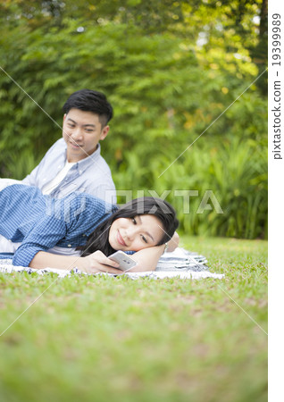 A couple sharing some relaxing moment in nature. A couple sharing some relaxing moment in nature. 19399989