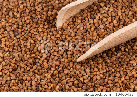 Uncooked buckwheat on wooden spoon 19400455