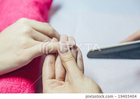 Manicure. Beauty saloon. Close-up. Remove old nail 19403404