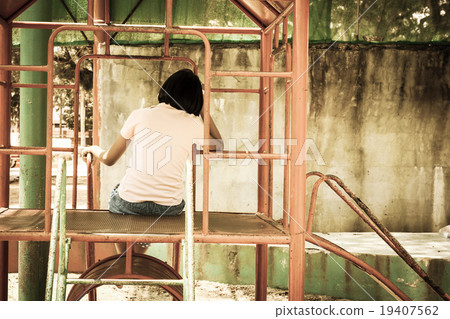 cute asian girl sitting alone at playground 19407562
