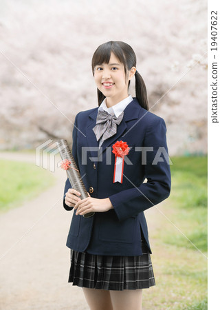School girls in uniform in standing on cherry blossoms in full bloom School girls in uniform in standing on cherry blossoms in full bloom 19407622