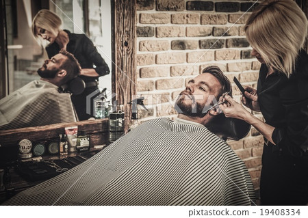 Client during beard and moustache grooming in barber shop Client during beard and moustache grooming in barber shop 19408334