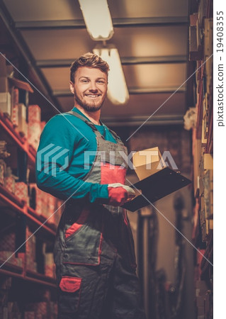 Worker on a automotive spare parts warehouse 19408355