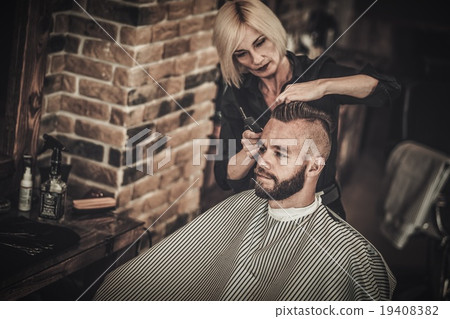 Client visiting hairstylist in barber shop Client visiting hairstylist in barber shop 19408382